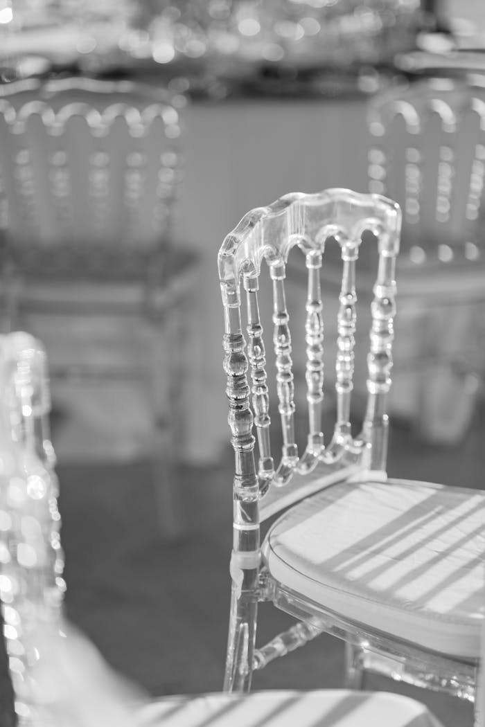 Sophisticated transparent chairs arranged for a wedding in Italy, creating a modern and elegant atmosphere.